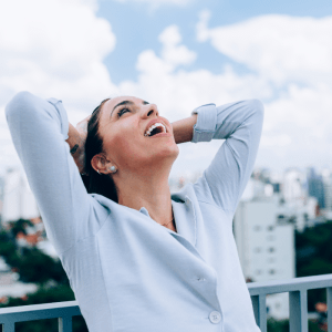 woman in blue shirt displaying emotion of relief