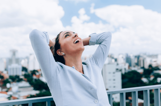 woman in blue shirt displaying emotion of relief