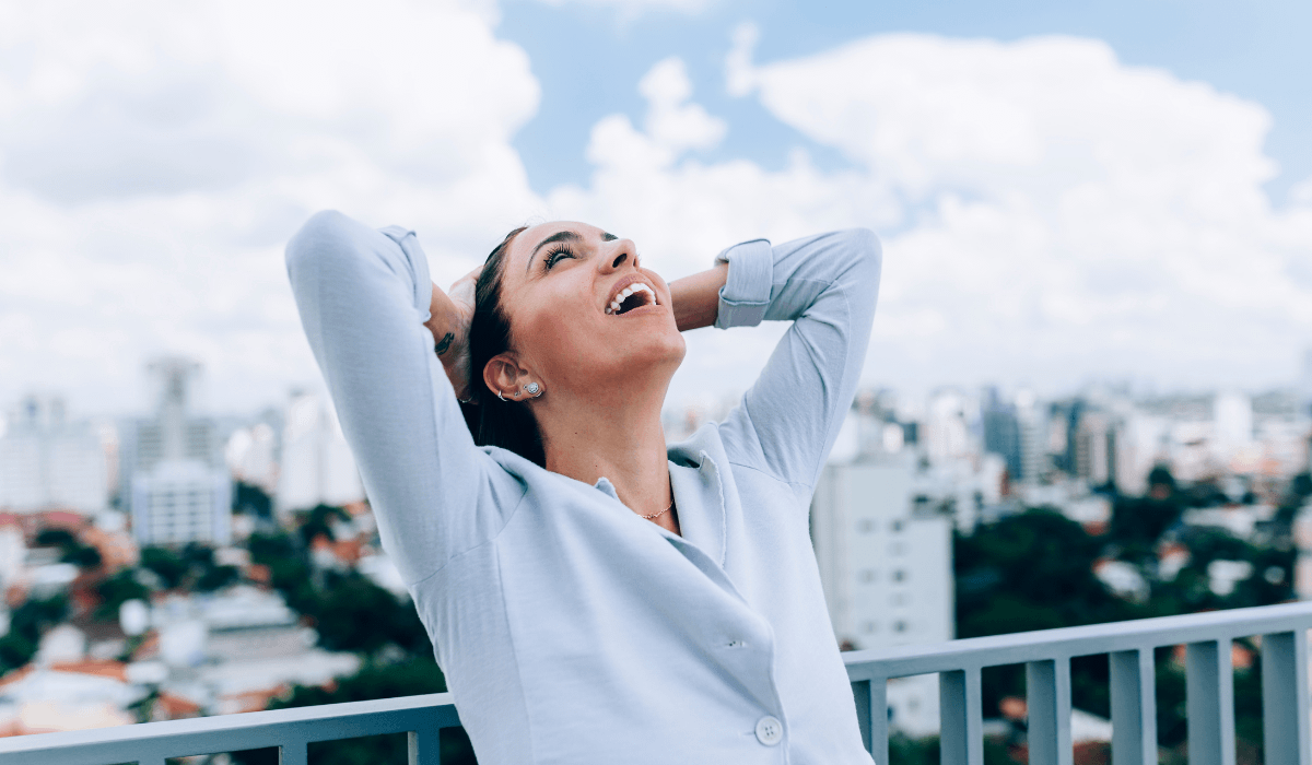 woman in blue shirt displaying emotion of relief