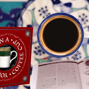 coffee cup reading book in red against mosaic background