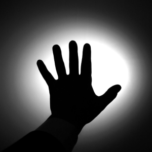 black and picture of hand against light