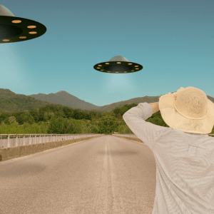 man wearing a hat facing UFO