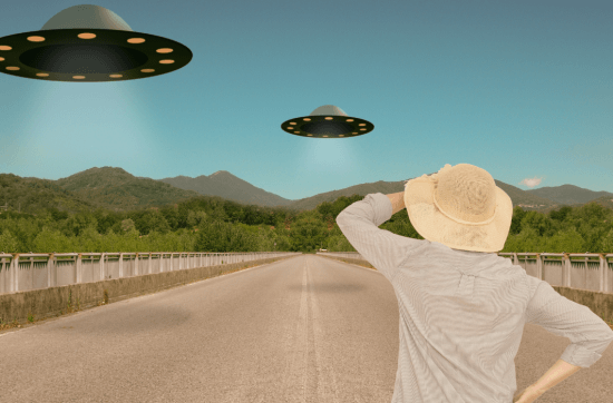 man wearing a hat facing UFO