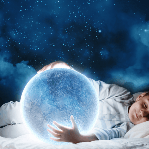 child sleeping holding a crystal ball with dream in it