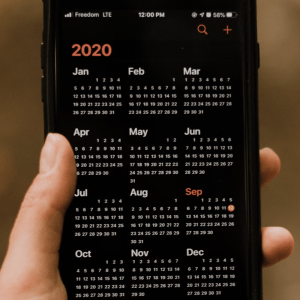 hand holding mobile calendar of 2020