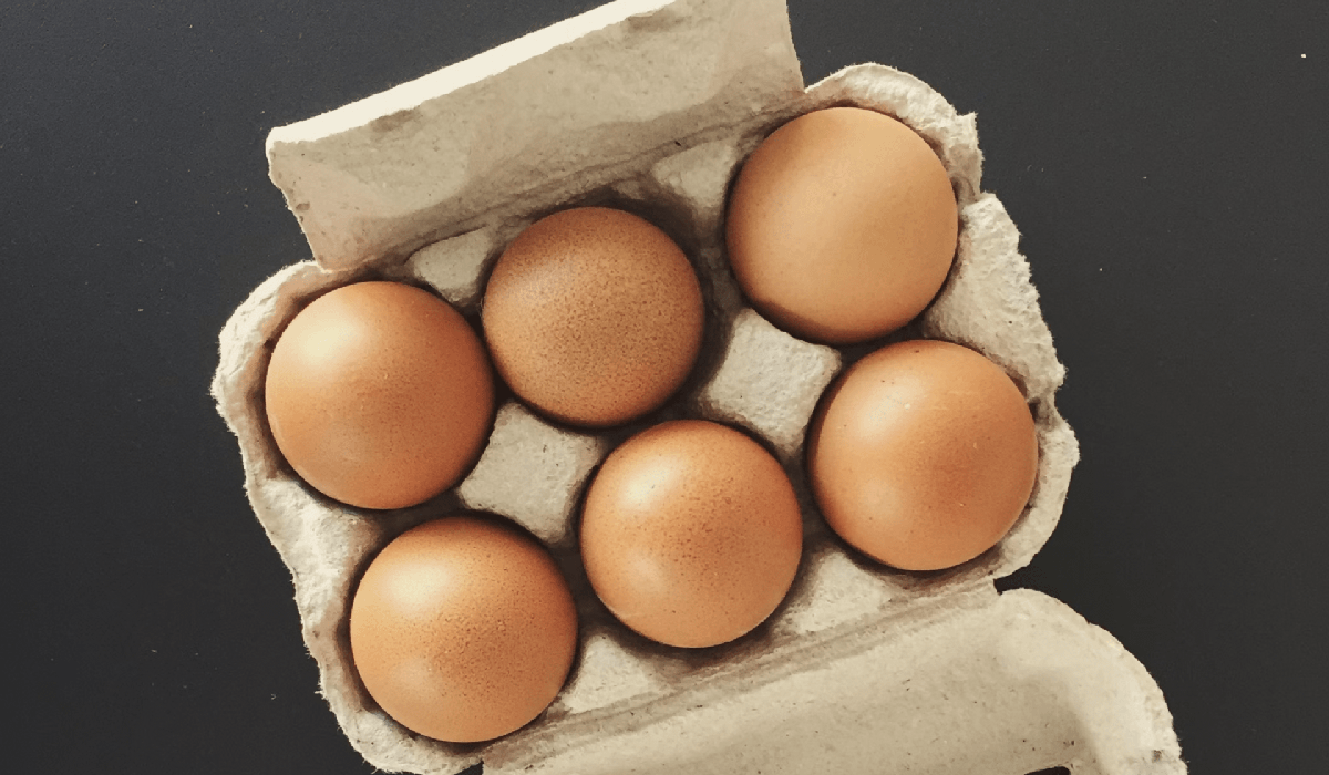 top view of six brown eggs in a package