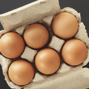 top view of six brown eggs in a package