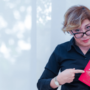 Sahar Palmer in black shirt holding red book