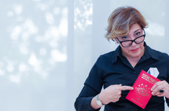 Sahar Palmer in black shirt holding red book