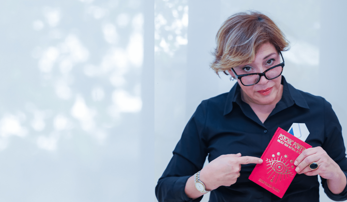 Sahar Palmer in black shirt holding red book