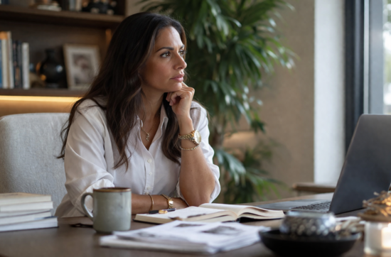 Professional creator paused in front of a laptop, looking uncertain and not taking action, illustrating hesitation despite clarity Unbox with Sahar Blog