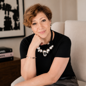 Intuitive Life Mentor in Dubai, Sahar Huneidi Palmer, in black top sitting on beige armchair