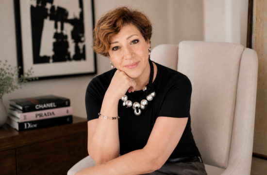 Intuitive Life Mentor in Dubai, Sahar Huneidi Palmer, in black top sitting on beige armchair