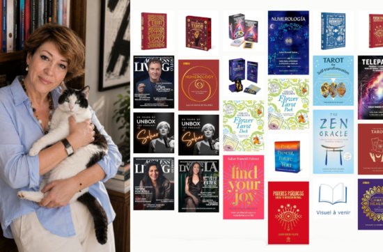 Intuitive Life Mentor, Sahar Huneidi Palmer standing holding her black and white cat by her book case, displaying new books that have been translated into Spanish